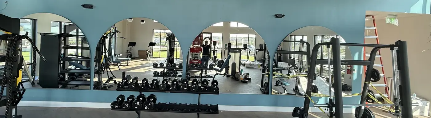 Custom arched mirror wall for a community fitness center